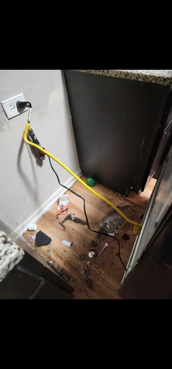 Before: floor behind kitchen appliances cleaning